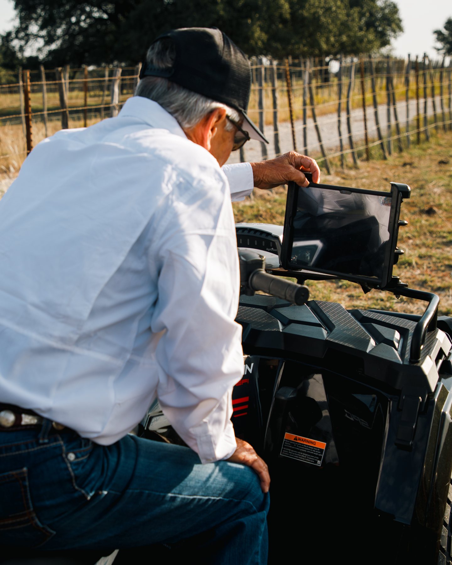 Technician checking the GPS mapping tablet on an ATV